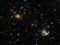 Хаббл показав дуже далеку галактику тричі на одному зображенні